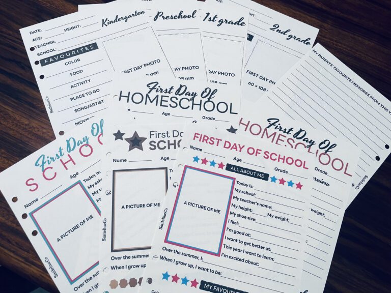 Organizing a stack of school and homeschool memory-keeping pages on a wood table