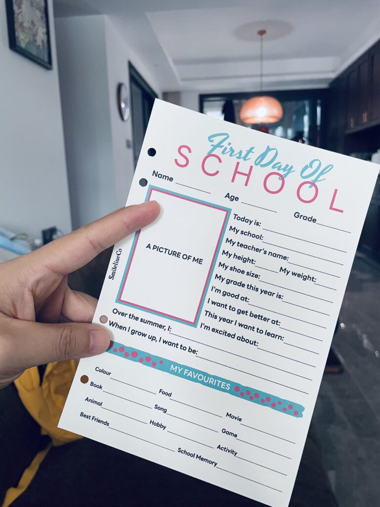 Excited hand pointing to the photo spot on a back-to-school keepsake card at home