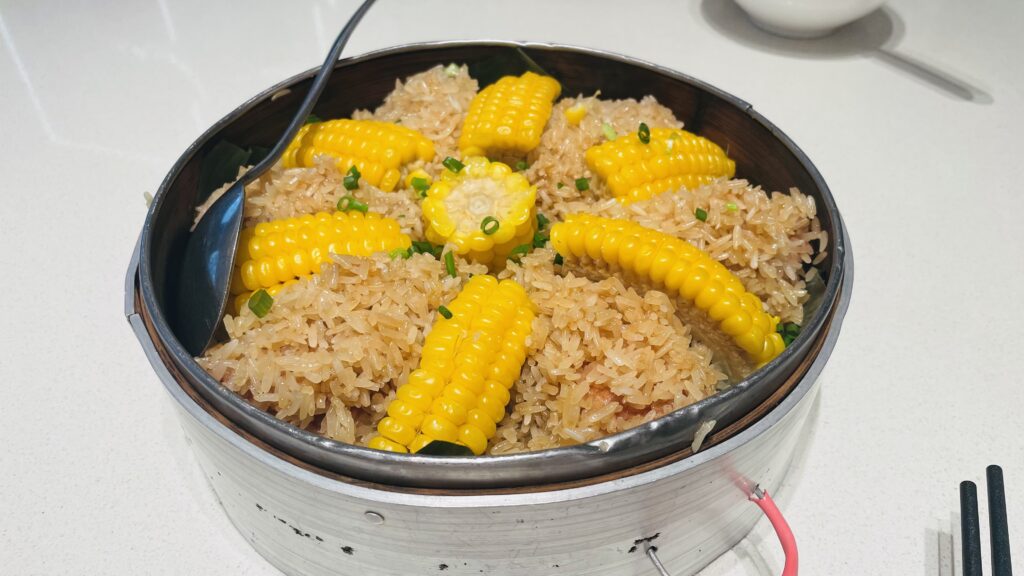 Sticky rice chicken wings with corn served in a bamboo steamer