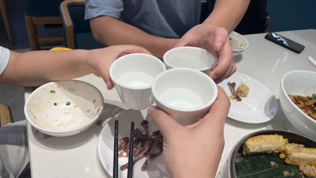 Family members toasting with tea cups during dinner