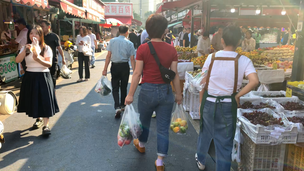 Crowded lane inside a Chinese wet market on a weekend morning in Changsha