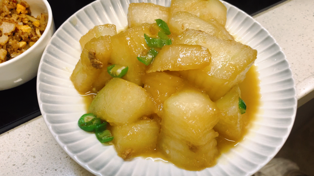 Braised winter melon being cooked in a Chinese home kitchen