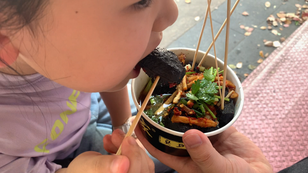 Black stinky tofu in China, fried until dark and crispy, with sauce